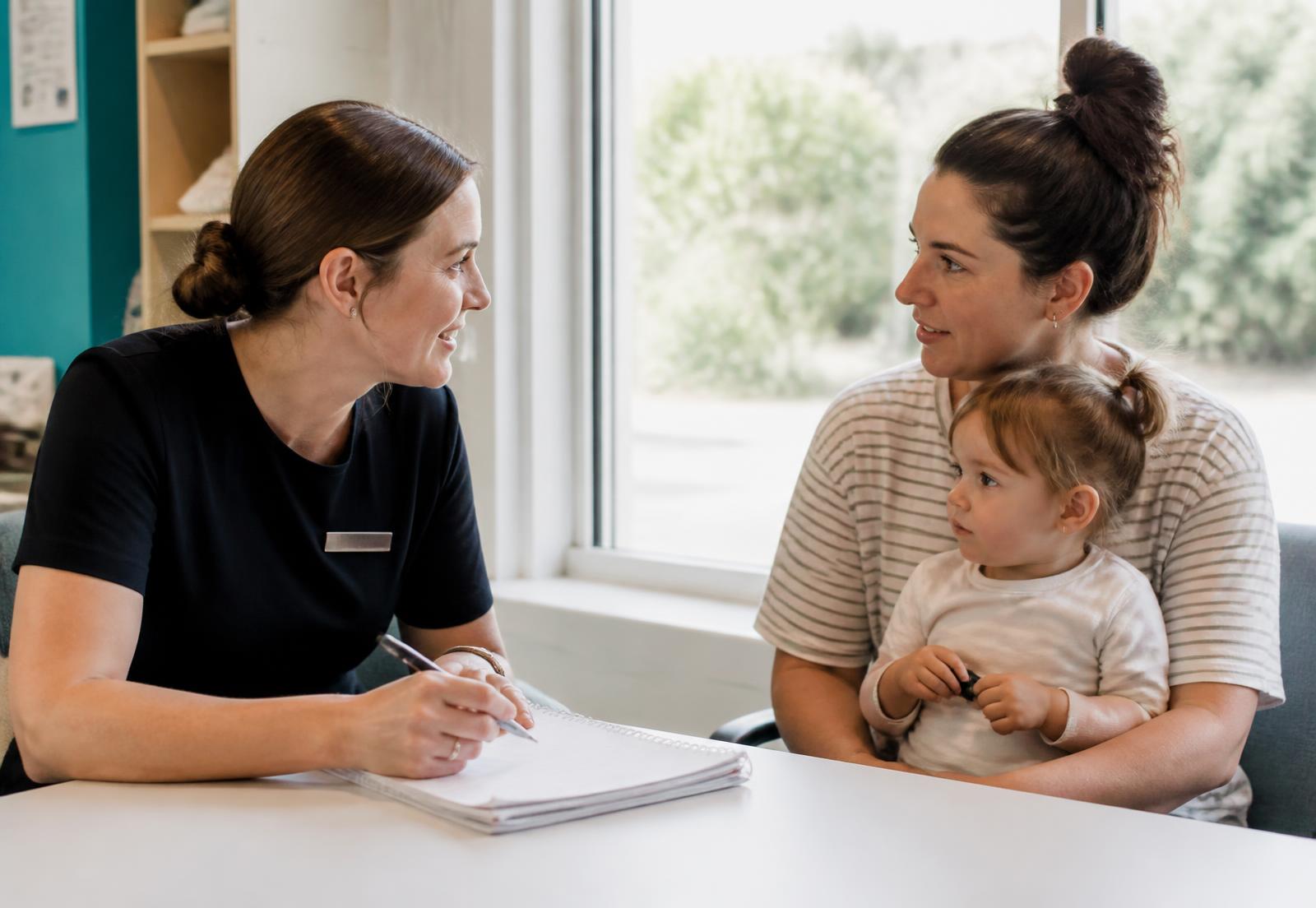 A child health nurse talking with a mother and her toddler at a community health centre in New South Wales